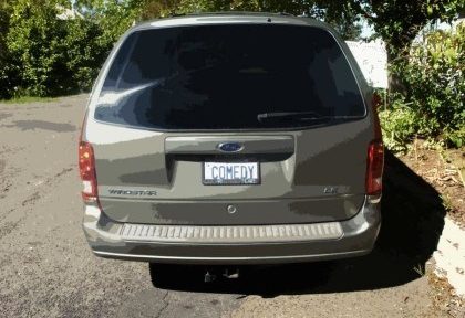 Picture of Robb's minivan featuring his license plate with the word "COMEDY." This is really his plate!